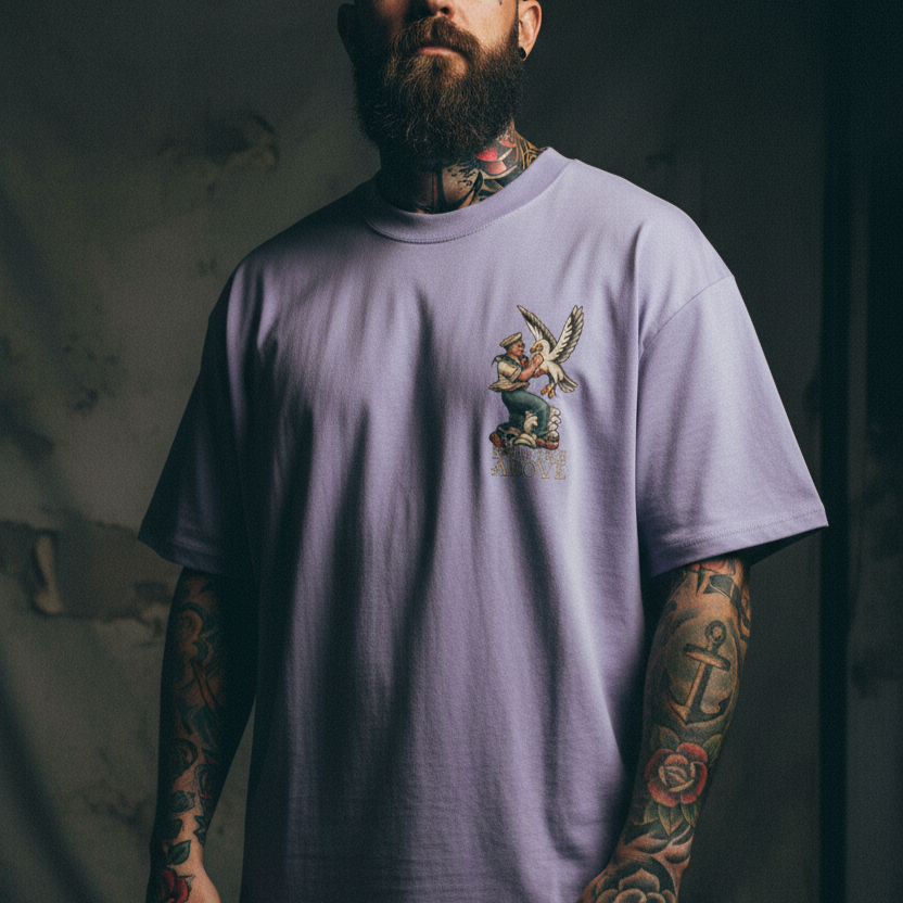 Man wearing a light purple t-shirt with a graphic design on a dark background