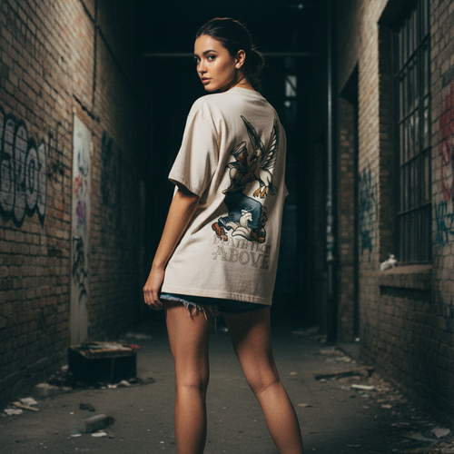 Woman wearing a graphic backprint tattoo t-shirt in an alleyway with graffiti.