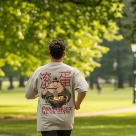 Man wearing an oversized funny graphic t-shirt with a funny slogan in a park
